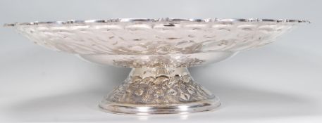 A large early 20th Century silverplate centrepiece tazza having repousse fruit and floral decoration