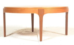 A retro 20th Century veneered teak coffee table of round form having solid teak wood tapering legs.