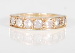 A hallmarked 9ct gold 7 stone ring. The ring having 7 round mixed cut white stones within a