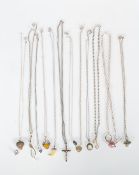A selection of silver pendant necklaces to include a crucifix, heart locket, a flat link chain