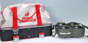 A set of four Drakes Pride professional bowls R5 4610 size 4M complete is green canvas carrier,