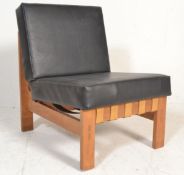 A vintage retro mid Century 1960's black leather lounge chair having an angular teak wood frame with