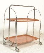 A retro mid century chrome and wooden trolley  by Gerlinol Brenshey Dinett. Raised on original