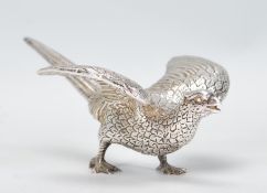 A good silver plated heavy cast metal Pheasant paperweight ornament of a fighting cock in an