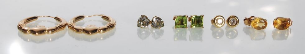 A collection of 9ct gold earrings to include a hoop pair with heart shaped motif and 4 pairs of stud