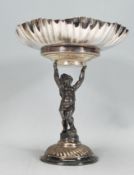 An early 20th Century silver plate tazza centerpiece having a round crimped flared rim with embossed