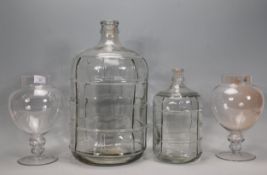 A pair of vintage style pedestal glass sweet jars together with two graduating glass olive / oil