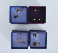 A collection of 9ct gold earrings, five pairs in total to include a pair of mystic topaz, garnet