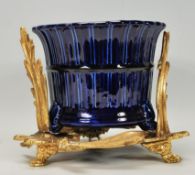 A gilt metal rococo planter stand together with cobalt blue ceramic glazed plant pot.  Measures 20cm