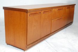 A retro 20th Century teak wood lowboard / sideboard having a configuration of two central drawers