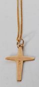 A 9ct yellow gold cross having engraved starlike decoration on a 9ct yellow gold chain. Both