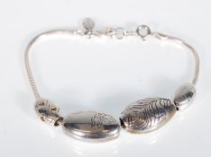 A Sterling silver designer Kit Heath bracelet with gas pipe chain adorned with fish decorated