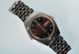 A vintage gentleman's F77 stainless steel cased automatic wrist watch having a round red enamelled