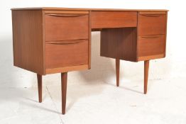 A 1970's retro vintage teak wood twin pedestal desk having two banks of two drawers to either side