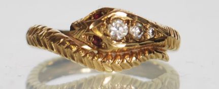 A hallmarked 9ct gold snake ring. The snakes head set with graduated white stones having ruby set