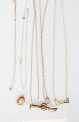 A group of five 9ct yellow gold necklace chains with one having a 9ct gold pendant with a J