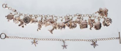 A silver 925 charm bracelet adorned with many charms to include house, train, teddy, car, clock,