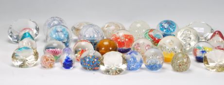 A large collection of approximately 30 20th Century paper weights to include some diamond  shaped