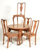 An Edwardian oak oval wind out dining table together with a single leaf extension having a set of
