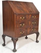 An early 20th century Queen Anne walnut bureau raised on ball and claw feet with cabriole legs.