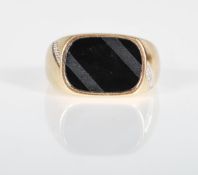 An English hallmarked 9ct gold ring having a black stone panel to the head having white accent