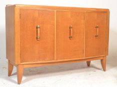 A mid century G-Plan light oak sideboard credenza having and angled, deep and wide body with three