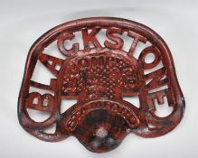 A 20th Century reproduction industrial style cast iron Blackstone tractor seat with pierced