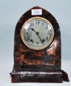 An early 20th Century faux tortoise shell bakelite mantel clock of domed form having a round face
