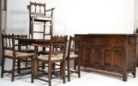 A mid century Ercol solid oak Old Colonial dining room suite. To include sideboard, draw leaf /