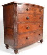 A Victorian 19th century mahogany bow front chest of drawers being raised on turned squat bun feet