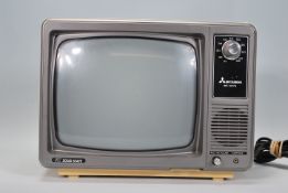 A vintage 1970's Mitsubishi BB 1207B IC solid state television set, case in cream plastic with