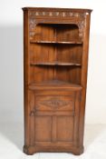 A good Jacobean revival Ipswitch oak corner cabinet. Raised on squared legs with carved door