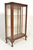 An early 20th Century Art Deco walnut display china cabinet, glazed single door with flanked by