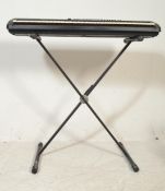 A Yamaha Portatone PSR-225GM electric portable keyboard having a digital display, silver control