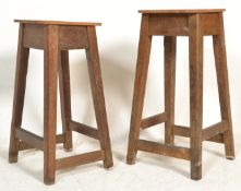 A pair of early 20th century church vestry stools of wooden construction raised on squared legs