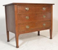An early 20th Century Arts and Crafts oak chest of drawers, three straight drawers fitted with brass