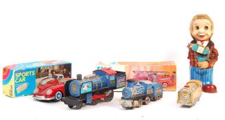 COLLECTION OF VINTAGE BATTERY OPERATED AND CLOCKWORK TOYS