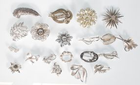 A group of 20 assorted vintage mid 20th Century 50's / 60's silver tone brooches to include a