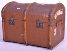 A vintage early 20th Century domed lid canvas trunk with wooden binding, retaining brown paintwork