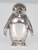 A silver figure of a penguin with engraved detail to the body glass eyes. Stamped sterling silver.