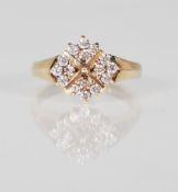 An English hallmarked 9ct yellow gold ring set with round cut white stone with decorative gold cross