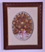 An early to mid 20th Century framed and glazed dried floral bouquet / garland interspersed with