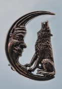 A ladies sterling silver engraved brooch. Taking the form of a dog howling at a smiling crescent