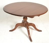 A 20th century Ercol beech and elm wood circular e