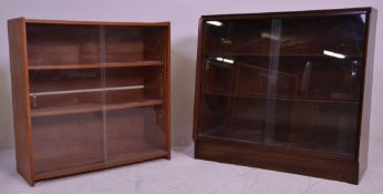 Two vintage 20th Century closed teak bookcase shelving units each having two shelves with glazed