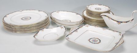A Wedgwood Bone China dinner service in the Osborne R 4699 pattern, consisting of eight dinner