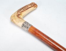 A 19th Century Victorian malacca walking stick cane having a horn handle to the top and a silver
