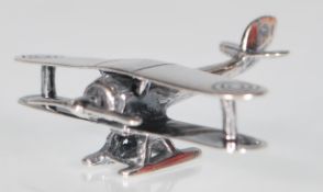 A small silver model of a Biplane featuring details such as the targets on the wings. Measures: 3.