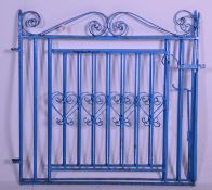 An early 20th Century 1930's iron twin door garden gate having scrolled details to the top, a square