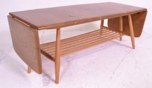 A retro 20th Century Ercol Golden Dawn beech and elm coffee table raised on tapering supports united